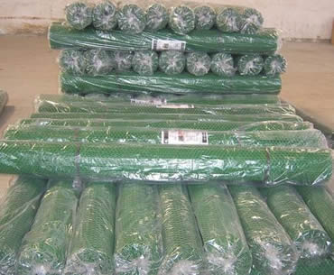 Rolls of dark green plastic mesh packed in plastic film with instructions inside